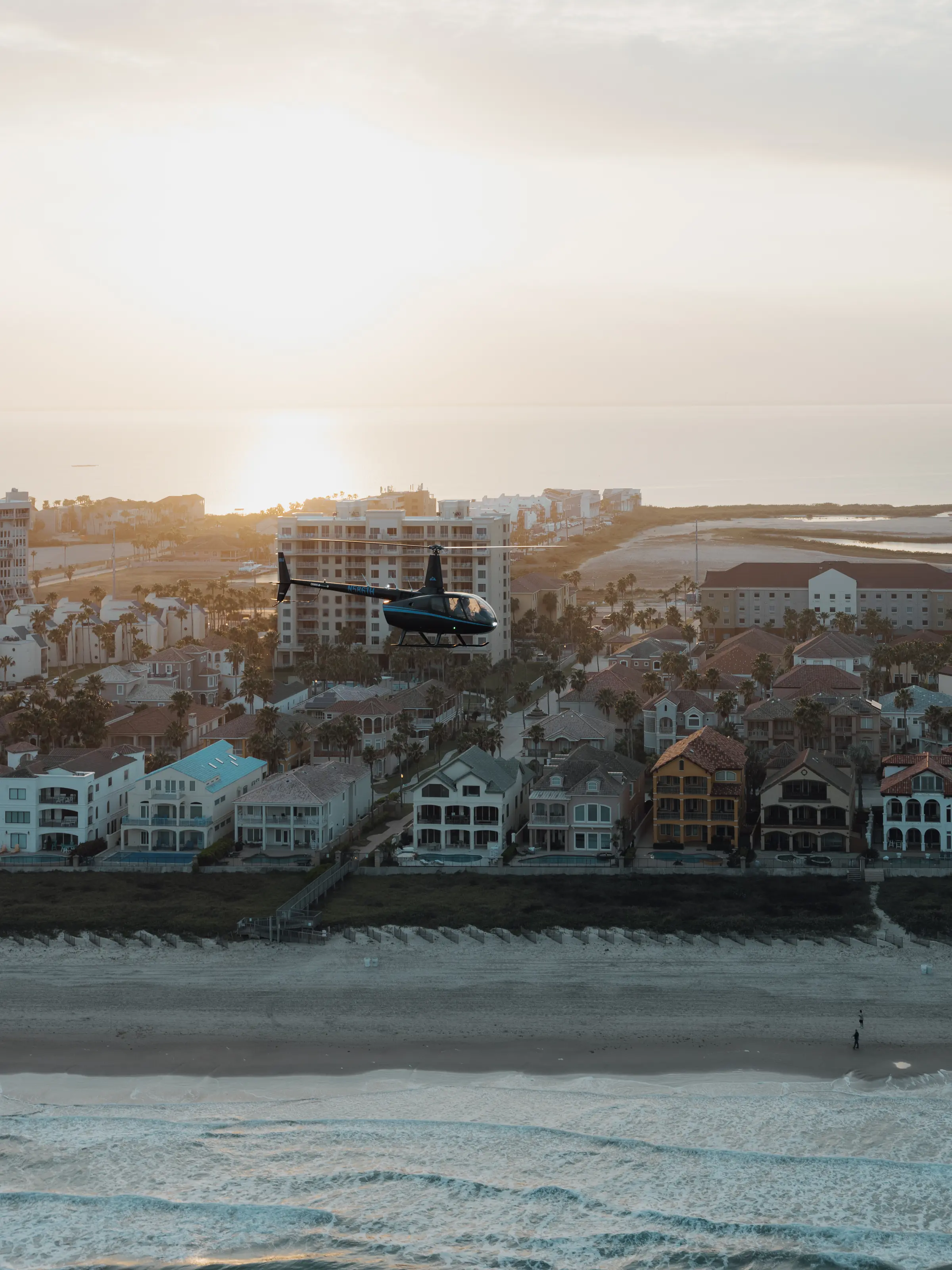 Aerial sunset over a beachfront town and the Gulf