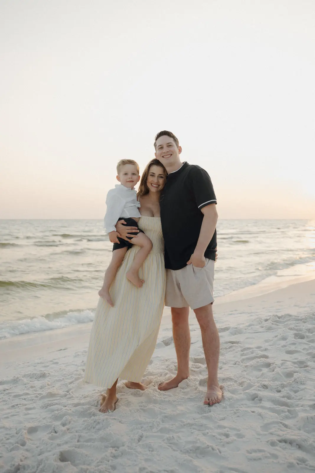 Family on the beach under a pastel sky