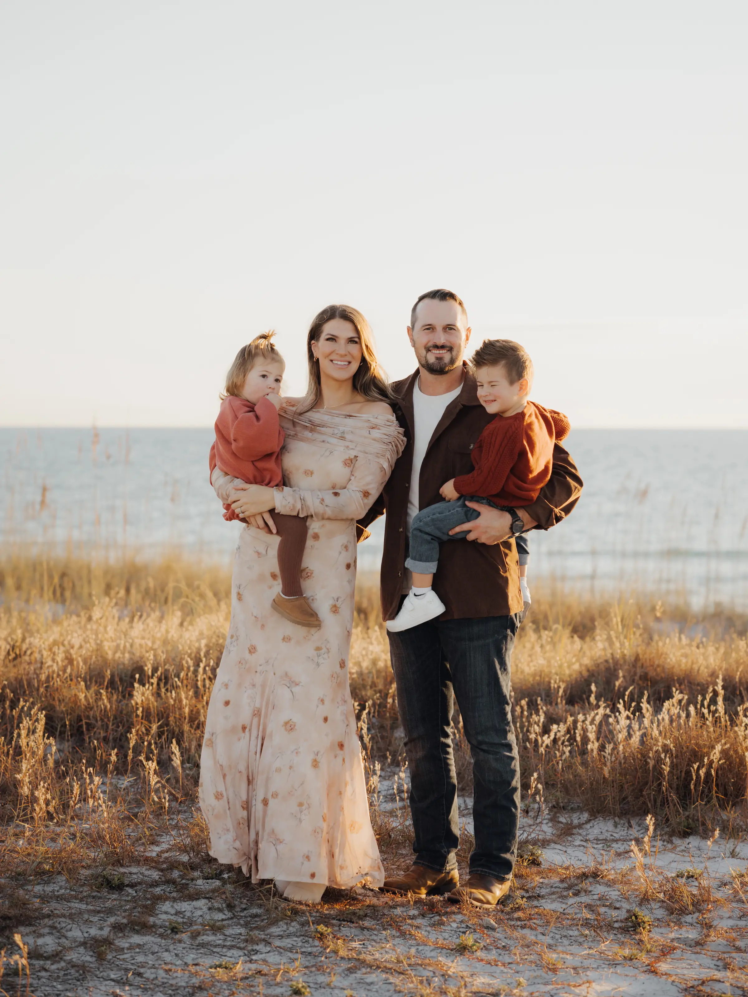 Family of four in the dune grass by the water