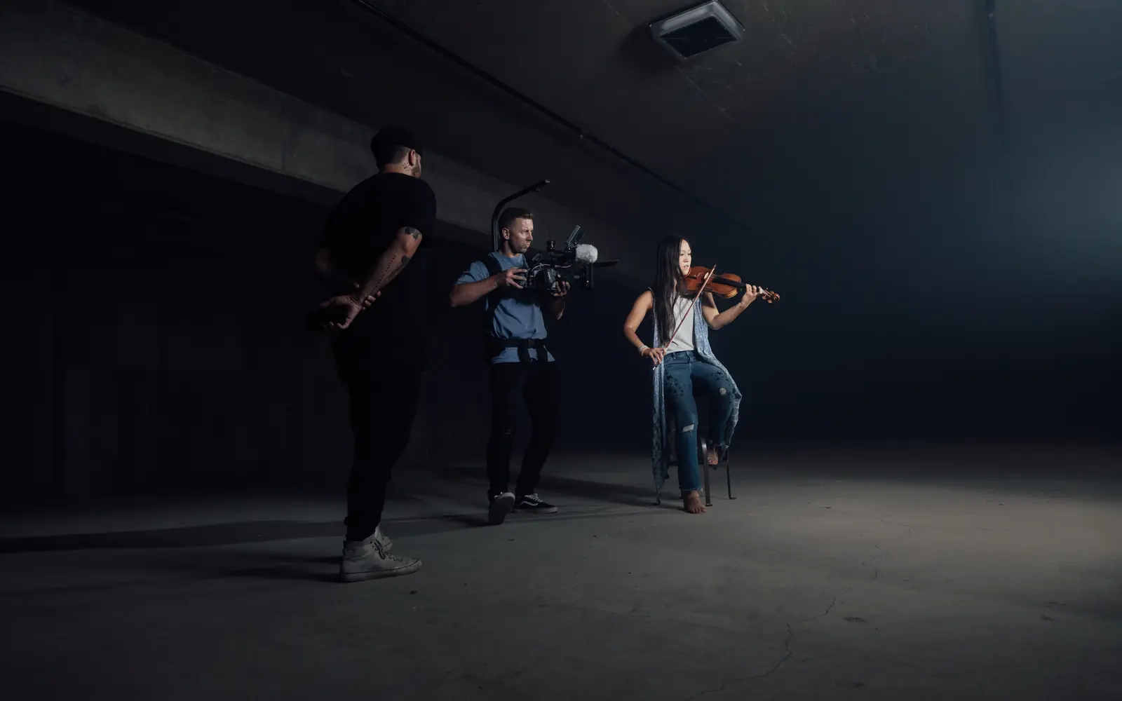 Musicians performing in a dark studio
