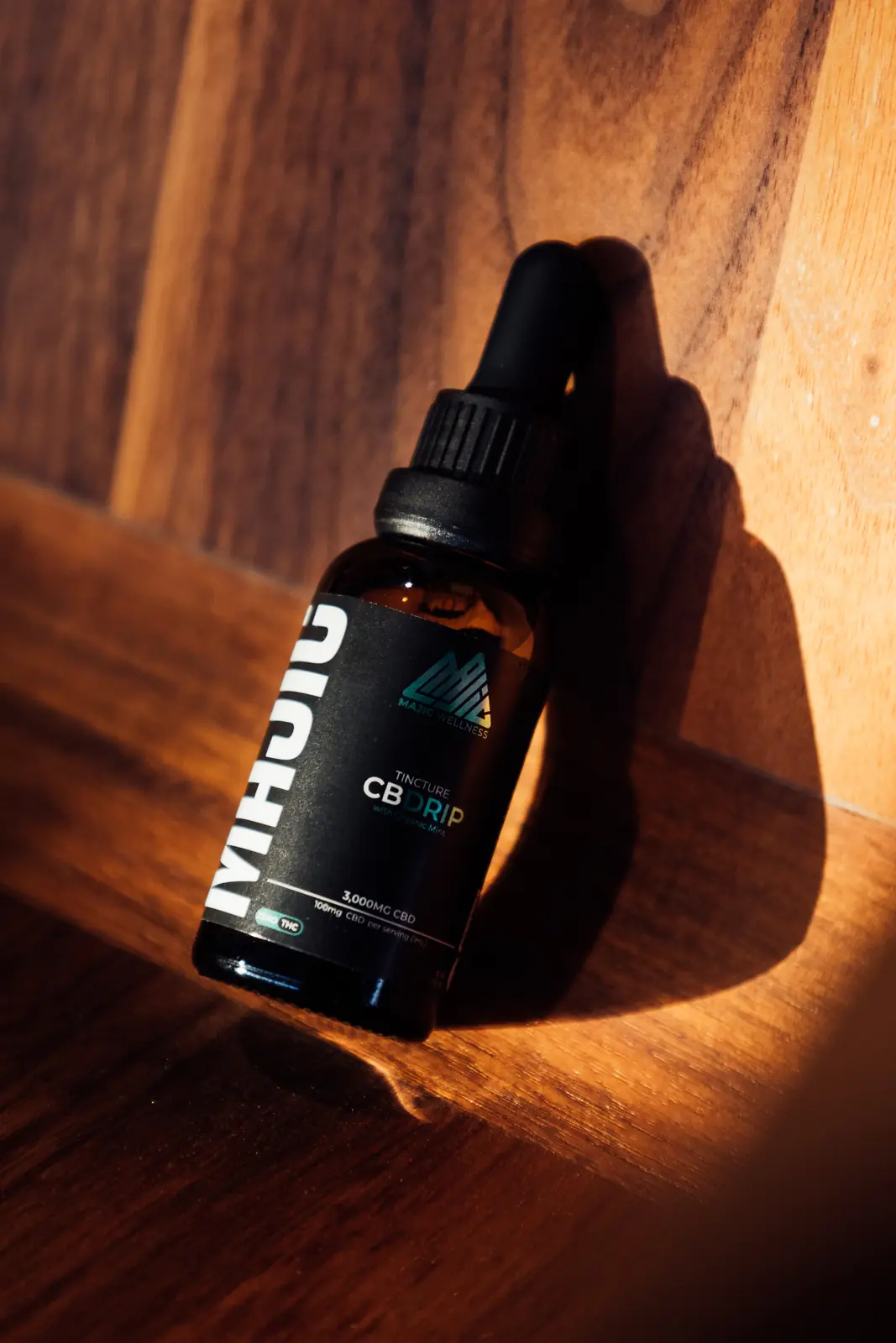 Dropper bottle product shot on wood in warm light