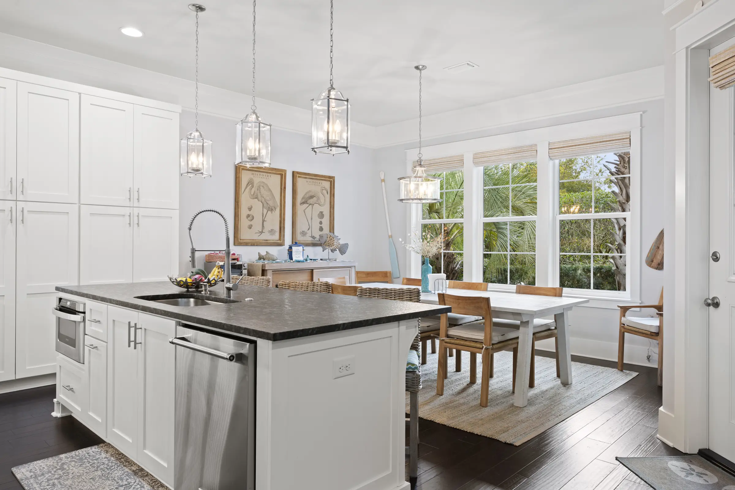 Open white kitchen with island and pendant lights