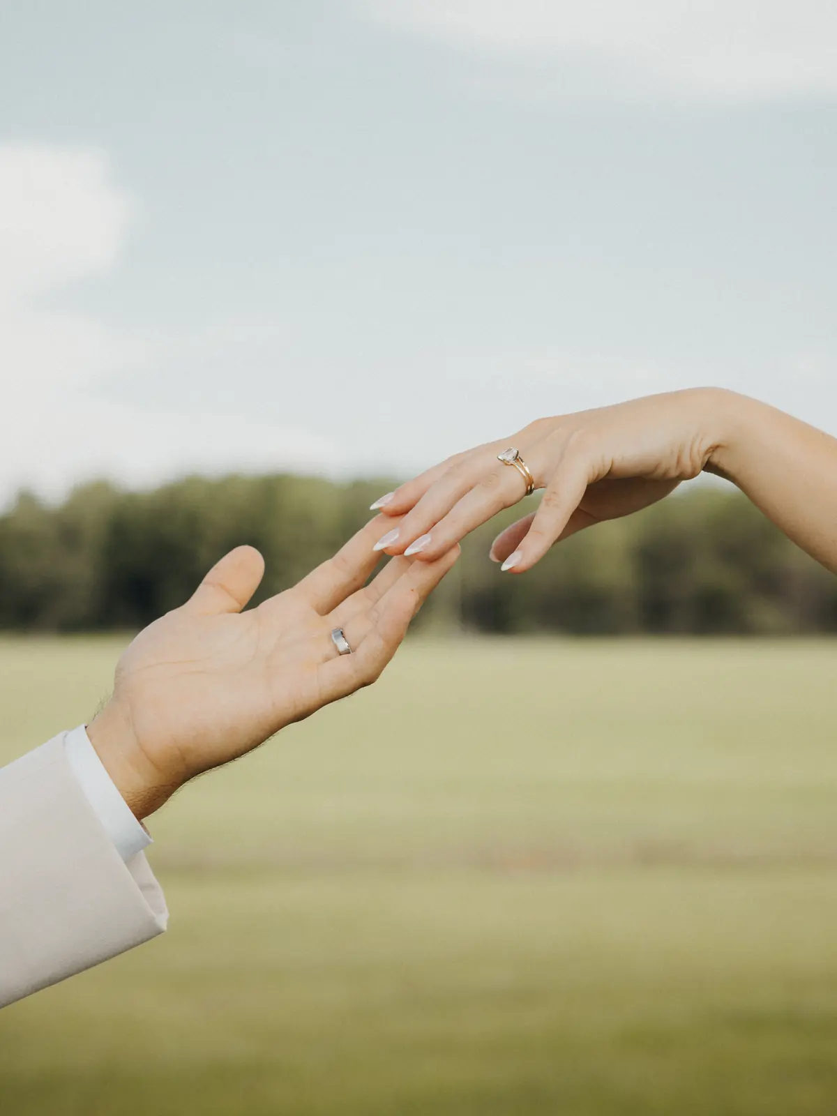 Close detail of the couple's hands and engagement ring